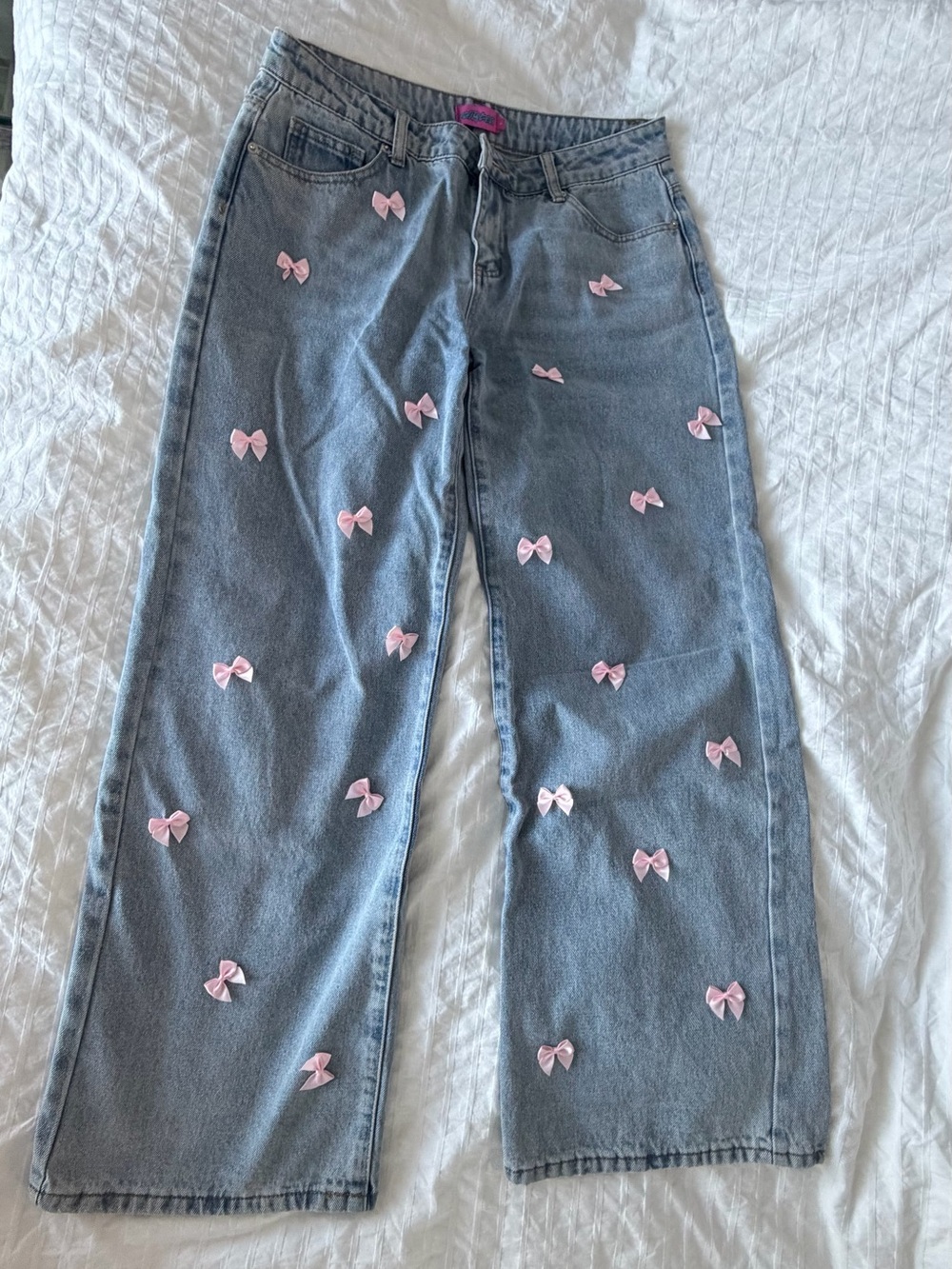 Edikted Women’s Light Blue Denim Jeans with Pink Bow Accents